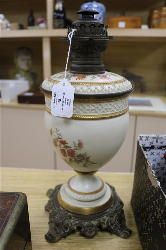 A Royal Worcester floral painted blush ground oil lamp height 42cm